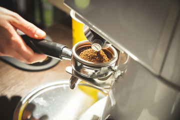 Close up of hands checking grinded coffee
