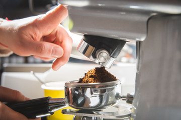 Close up of hands checking grinded coffee