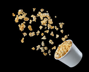 Popcorn flying out of the package isolated on black background