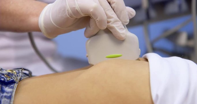 The doctor adjusts the ultrasound machine