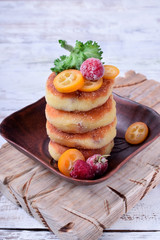 Cottage cheese pancakes with raisins topped with raspberry and kumquat slices. Breakfast idea