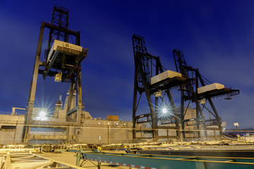 Fototapeta na wymiar Shipping Container Cranes in the Port of Oakland. Oakland, Alameda County, California, USA.
