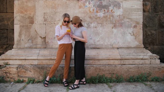 Two girls tourist enjoying old city view. Travel guide, tourism in Europe with friends.
