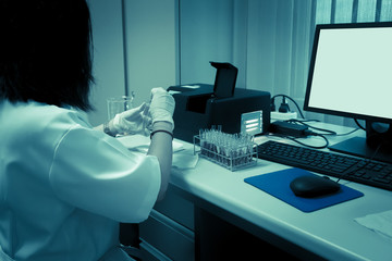 Scientist mix chemicals with The shake machine Before the experiment.Mixture laced with samples into test tubes,Thailand scientist working in the lab