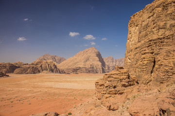 tourism photography of Wadi Rum Jordanian desert scenery landscape with sand valley and different steep and sharp rocky shapes