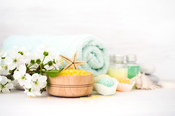 Aromatic salt for Spa therapies, cosmetics for a body and acceptance of bathtubs, towel and a spring flower. Care of a body. Alternative medicine.