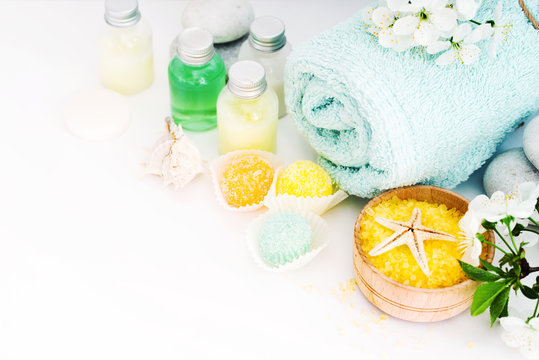 Aromatic salt for Spa therapies, cosmetics for a body and acceptance of bathtubs, towel and a spring flower. Care of a body. Alternative medicine.