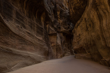 lonely track for tourists inside canyon between steep stone walls 