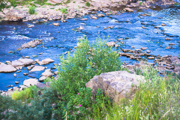 Summer Nature Landscape. Fast River and Old Ruined Stone Bridge on Shore