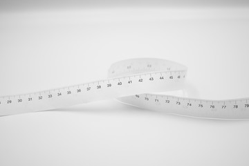 White measuring tape ruler metric measurement or diet concept isolated on white background.