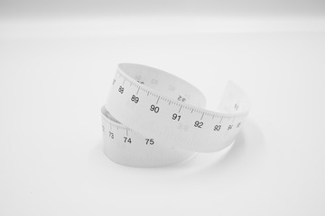 White measuring tape ruler metric measurement or diet concept isolated on white background.