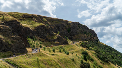 Big hill with people on trail