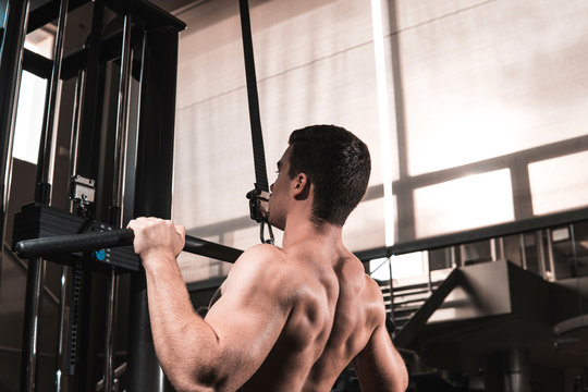 Young fitness man training in gym