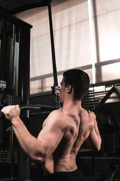 Young fitness man training in gym