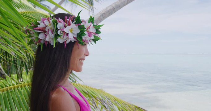 Tahiti beauty woman wearing flower head wreath traditional Tahitian cultural accessory flower crown. Bora Bora, French Polynesia. Beautiful Asian multiracial girl smiling happy.