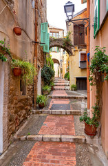 Fototapeta na wymiar Menton. Old narrow street in the historic part of the city.