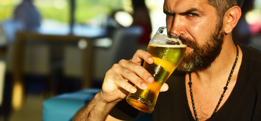 Man holding mug of beer. Sexy bearded man open smile and big mug of beer in his hand. guy at the bar counter.