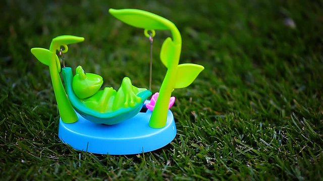 plastic frog hammock grass background hd footage 