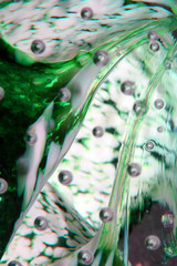 Macro Close Up of Inside a Paperweight Bubbles Glass Green Blue Water