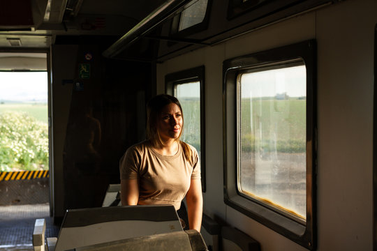 Female soldier looking out window while travelling through countryside in military vehicle