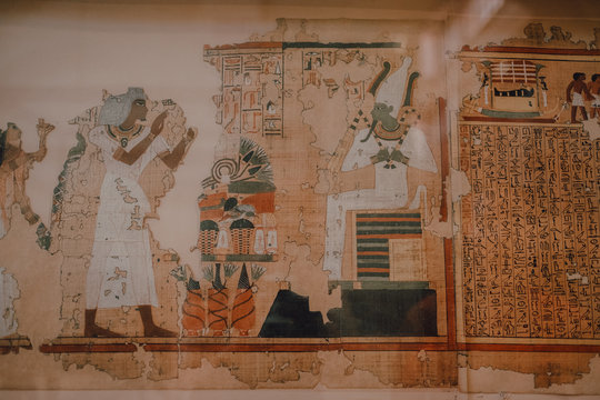 Cairo, Egypt - April, 12 2019: Crumbling ancient mural and hieroglyphs on wall of entombment