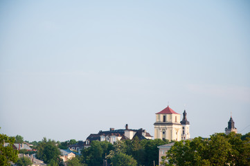 Old City. Tall tower. Green trees grow around. Summer.
