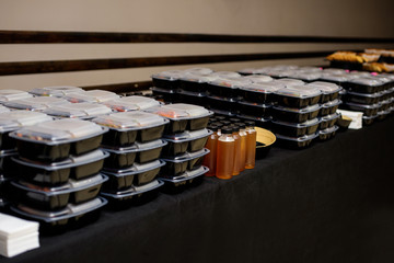 Black lunch box with food. Catering