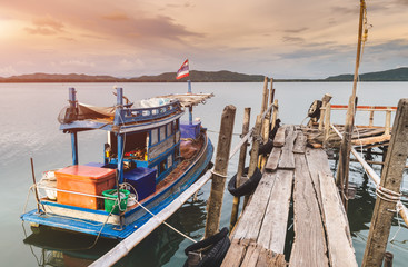 Fishery wooden boat at the shore lake scape.