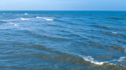 Aerial view of the blue waters of the Mediterranean Sea and specifically of the Tyrrhenian Sea. Sunlight is reflected on the surface of the water.