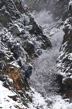 Fast stream of clean water flowing and splashing on rough mountain stones on sunny day in Spain