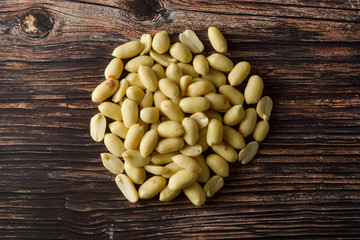 Raws peanut on wooden table, top view.