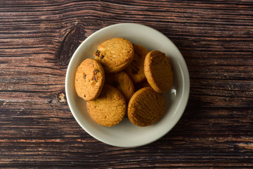 Oat and Chocolate chip cookies on rustic wooden table background