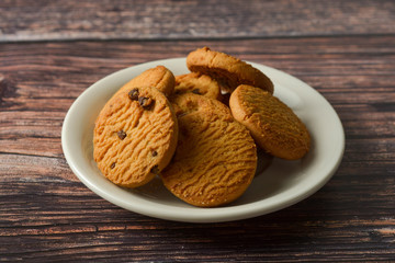 Oat and Chocolate chip cookies on rustic wooden table background