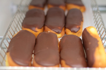 Fresh donuts on display racks at the donut shop.