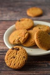 Oat and Chocolate chip cookies on rustic wooden table background