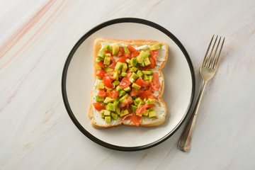 Toast with cream cheese, avocado and cherry tomatoes. Healthy food.