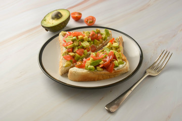 Toast with cream cheese, avocado and cherry tomatoes. Healthy food.