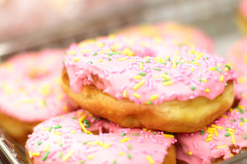 Fresh donuts on display racks at the donut shop.