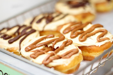 Fresh donuts on display racks at the donut shop.
