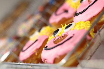 Fresh donuts on display racks at the donut shop.
