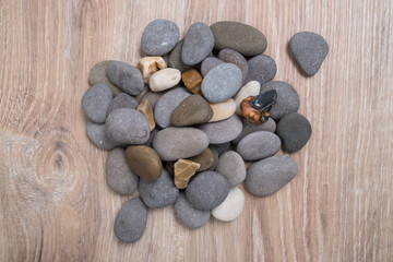 A bunch of sea stones. River stones on a wooden background. Smooth stones.