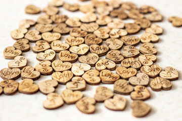 Many wooden hearts with the inscription love. wooden hearts with the inscription love. hearts with the inscription love. Small figurines of hearts