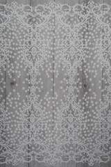 The texture of lace on wooden background