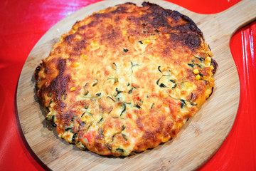 Custom made pizzas at home on appetizing brown wooden trays