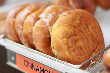 Fresh donuts on display racks at the donut shop.