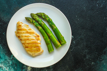 asparagus and chicken breast fillets grill, hollandaise sauce. food background. top
