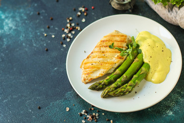 asparagus and chicken breast fillets grill, hollandaise sauce. food background. top