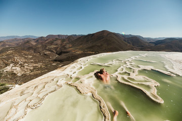Man relaxing in cold spring at Hierve el Agua, Oaxaca, Mexico