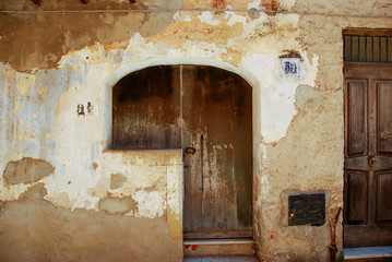 Fototapeta na wymiar old window on the wall of an ancient house in the medieval village of Pollina in Sicily