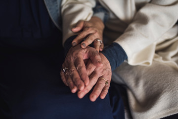 Close up of woman's hands on her daughter's lap